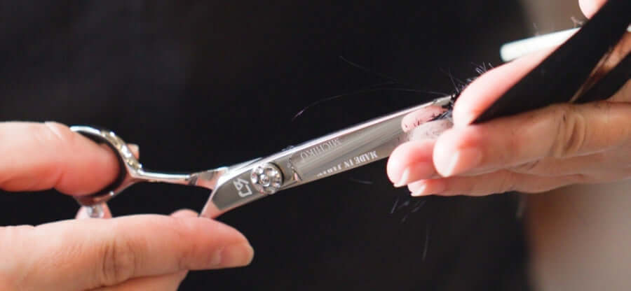 Hairstylist performing a precise haircut using Michiko shears