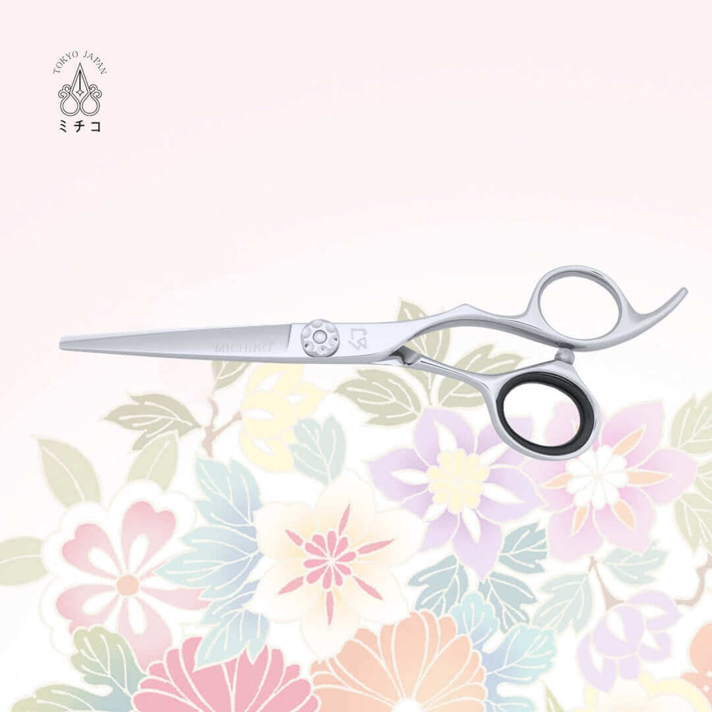 MICHIKO NIGATA 5.5-inch authentic Japanese hair cutting shears in a closed position, showing the MICHIKO letter logo on the cutting blade and illustrative logo under the screw area.