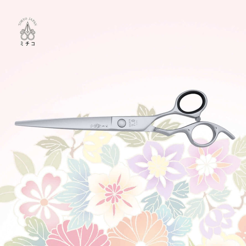 Authentic Japanese NIGATA 7-inch salon scissors in a closed position, showing the back side with a traditional Japanese lady in a Kimono as the MICHIKO symbol on the blade. Under the screw area, the model name, size, and serial number are visible.